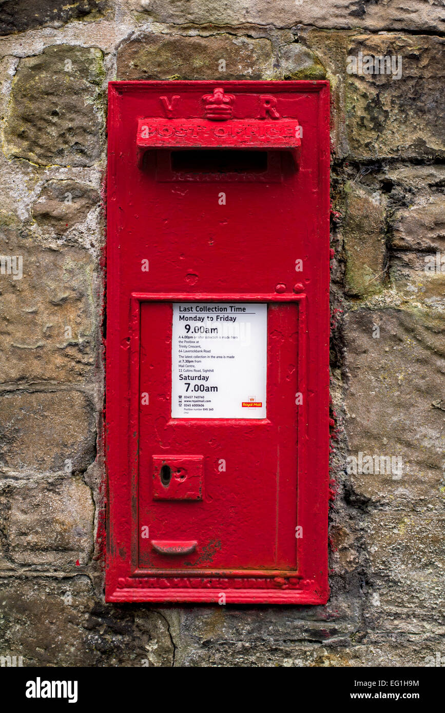 Red Victorian wall mounted post box still in use in Edinburgh, Scotland, UK Stock Photo