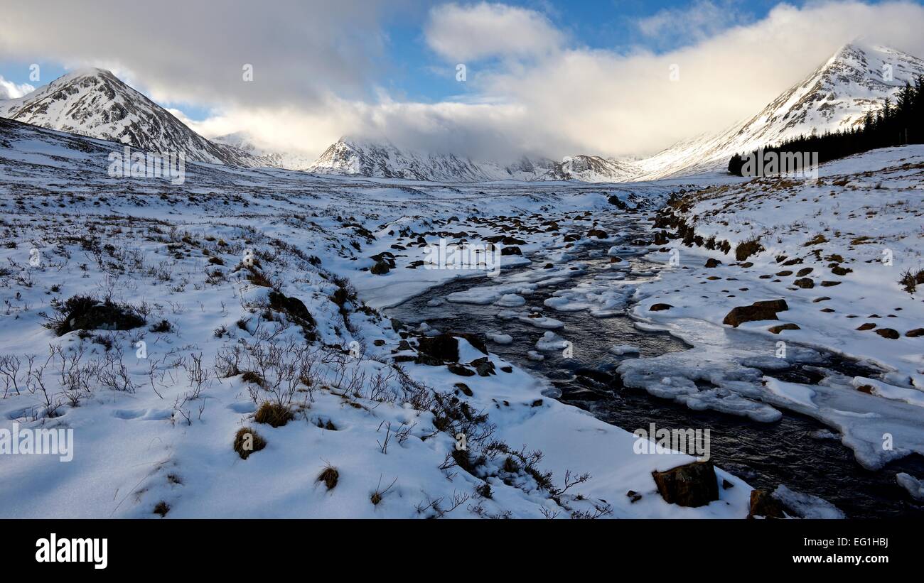 A cold winters day in Scotland with a snow covered landscape with views to the mountains that make up the Black Mount in Glencoe Stock Photo