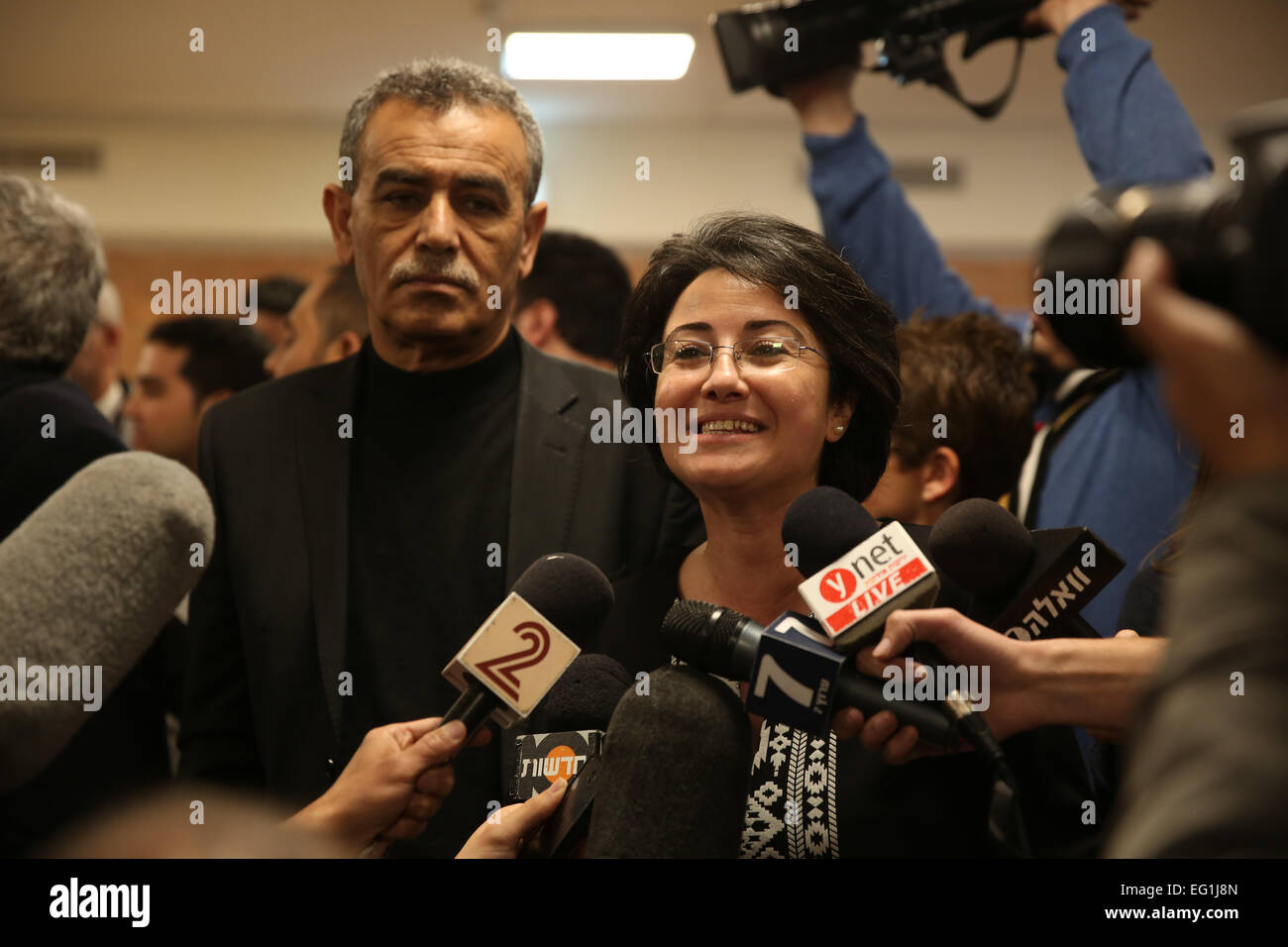 Jerusalem. 12th Feb, 2015. Arab Israeli lawmaker Hanin Zoabi (C) speaks to the press after a vote to disqualify her from running for Knesset elections at the Israeli Central Elections Committee in the Israeli Knesset (parliament) in Jerusalem, on Feb. 12, 2015. The Israeli Central Elections Committee decided on Thursday to ban an Arab lawmaker and a far right-wing activist from running in the upcoming elections due to their controversial public remarks. © JINI/Xinhua/Alamy Live News Stock Photo