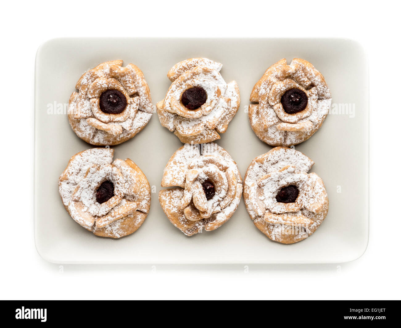 Plate with six crispy cookies with caster sugar and marmalade shot from above Stock Photo