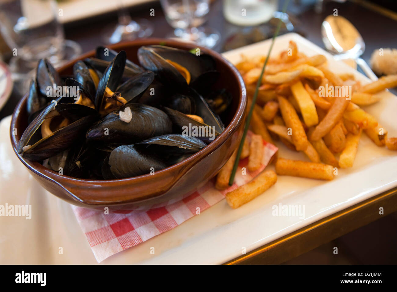 Mussels and French fries on a table in a French restaurant Stock Photo