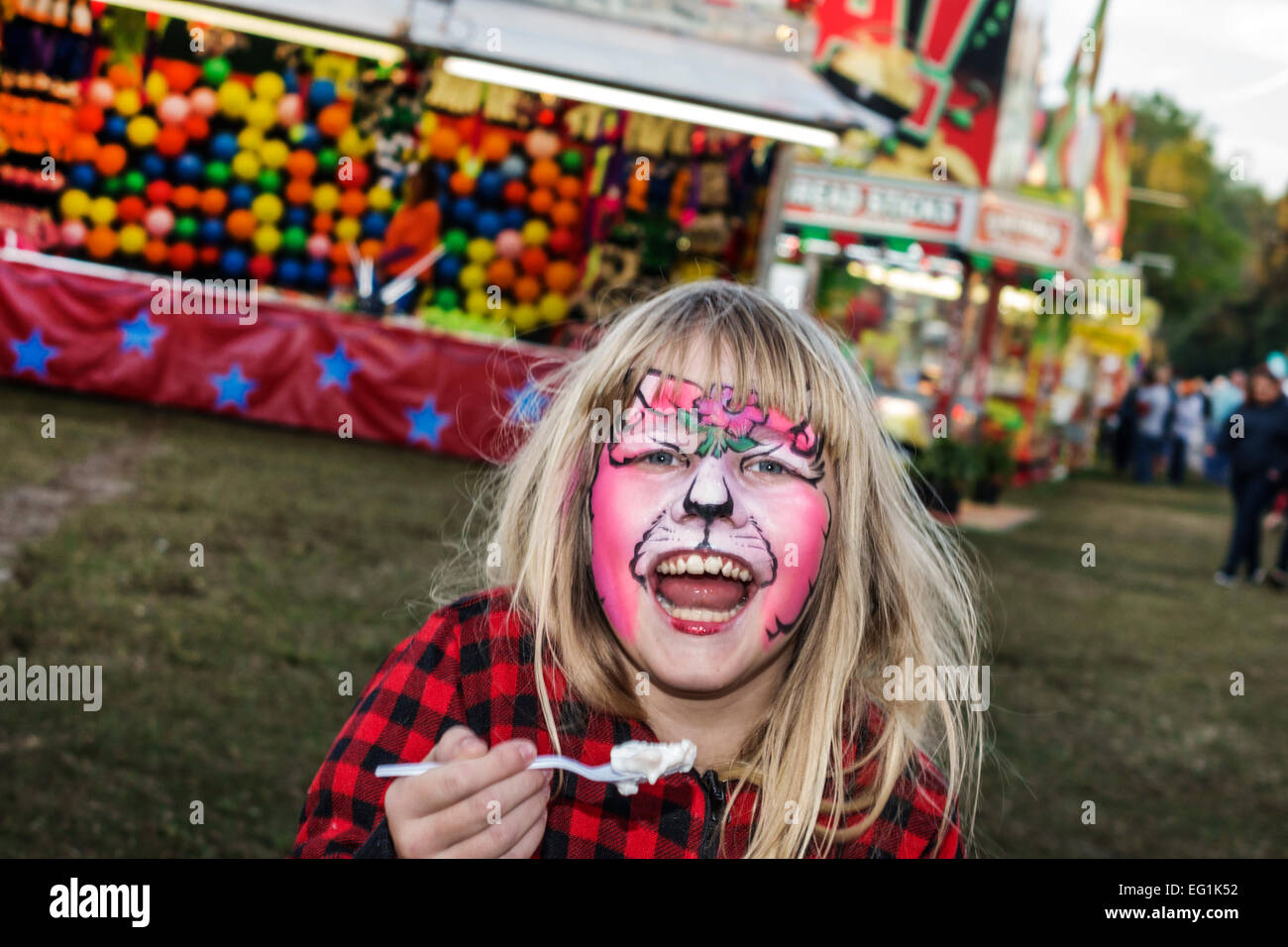 Florida Fellsmere,Frog Leg Festival,carnival,midway,girl girls,youngster youngsters youth youths female kid kids child children,face painting,eating,i Stock Photo