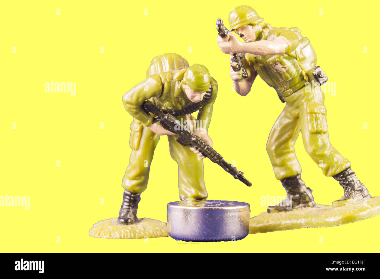 Discovery of a battery. Small toy soldiers found a battery Stock Photo