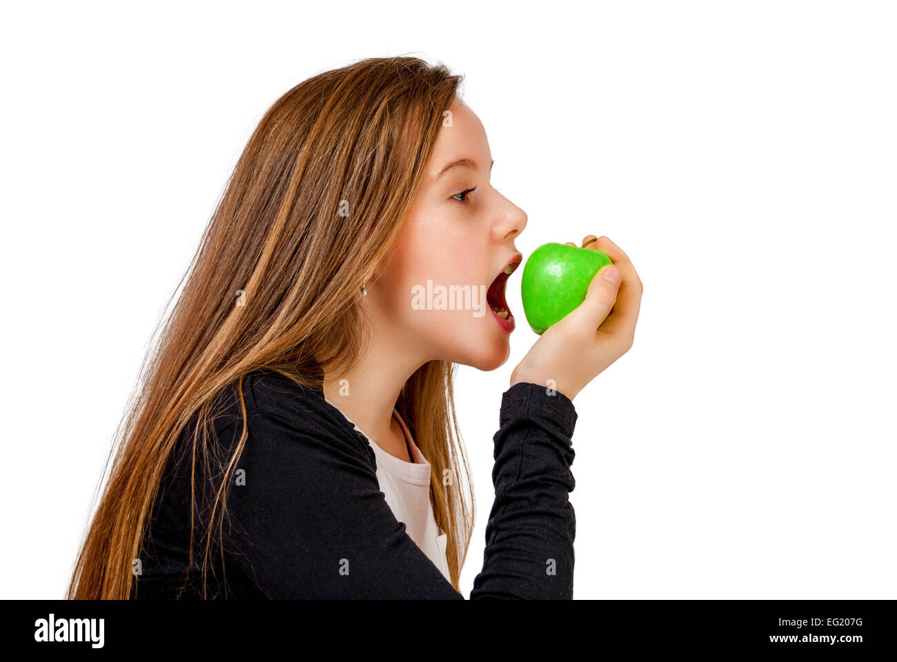 Little girl bite eat green apple isolated on white Stock Photo