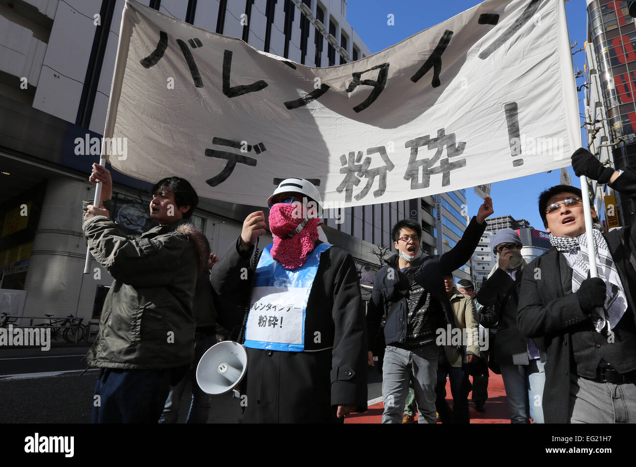 Demonstrators take part in 'Smash Valentine's Day' protest as they march through the streets of Shibuya district in Tokyo, Japan on February 14, 2015. The group called Kakuhidou, meaning 'Revolutionary alliance of men whom women find unattractive' protested that Valentine's Day is only about marketing and making money by chocolate companies. © Yuriko Nakao/AFLO/Alamy Live News Stock Photo
