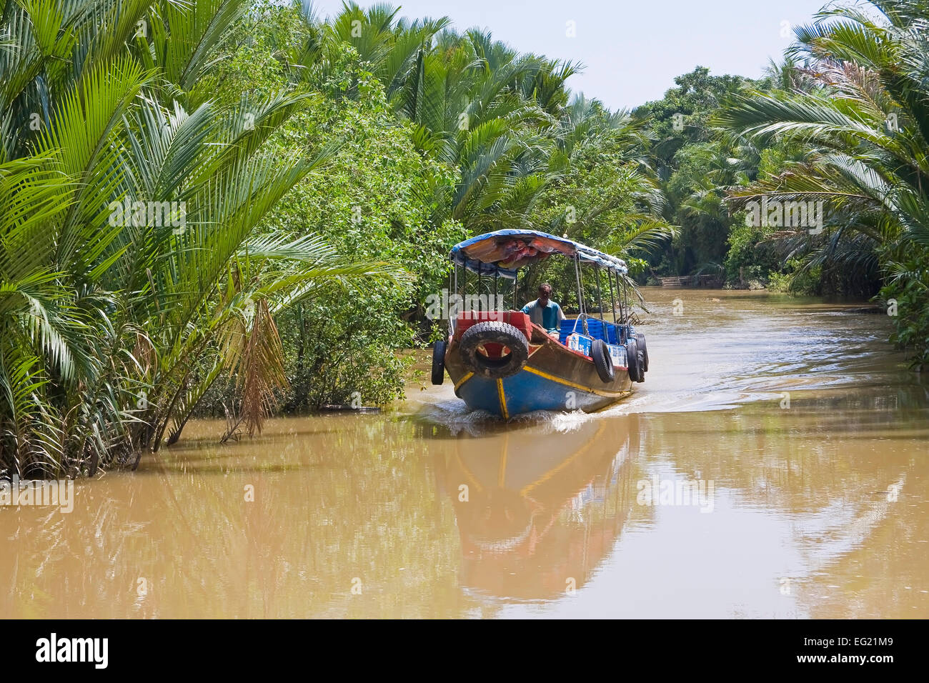 Excursion boat in a side channel of the Mekong, Mekong Delta, Vietnam, Asia Stock Photo