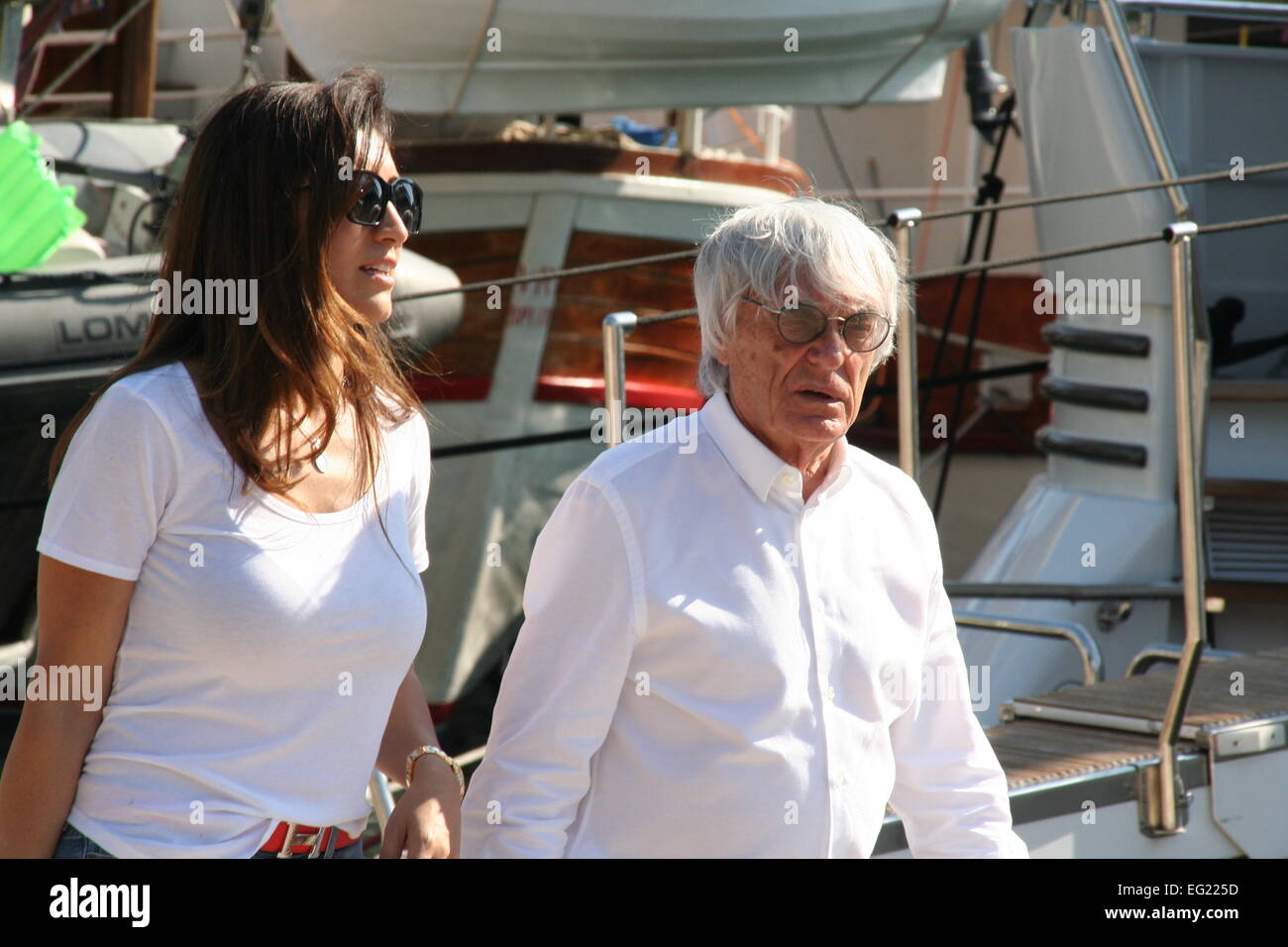 The boss of F1, Bernie Ecclestone, enjoyed a stroll around the port of Gruz with his wife Fabiana Flosi. The couple have been holidaying aboard Bernie's luxury yacht Petara. Ecclestone had been on trial in Munich, accused of bribery involving the sale of an F1 stake to CVC Partners in 2005-06, but walked free from the court after the judge accepted a record $100m offer to settle the charges. The presiding judge, Peter Noll, announced that the court would accept the settlement offer, with $99m going into the coffers of the Bavarian state and $1m to a children’s charitable foundation.  Featuring Stock Photo