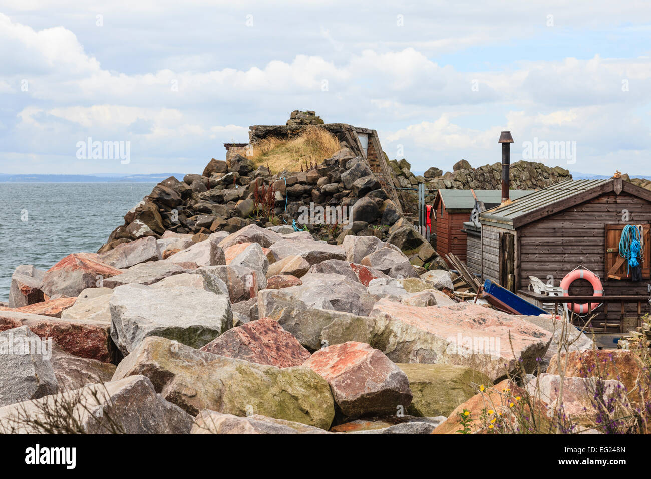 Rocky sea defences at Kinghorn harbour Stock Photo
