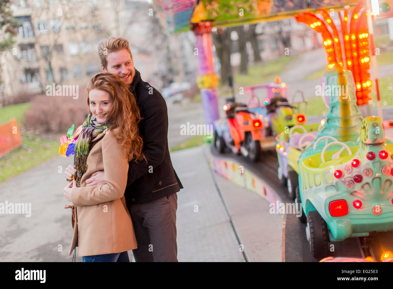 Young couple in the amusement park Stock Photo - Alamy