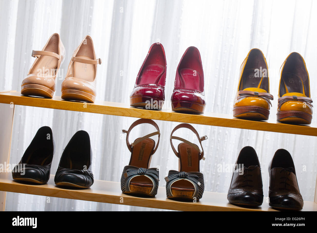 Various shoes on wooden shelves Stock Photo - Alamy