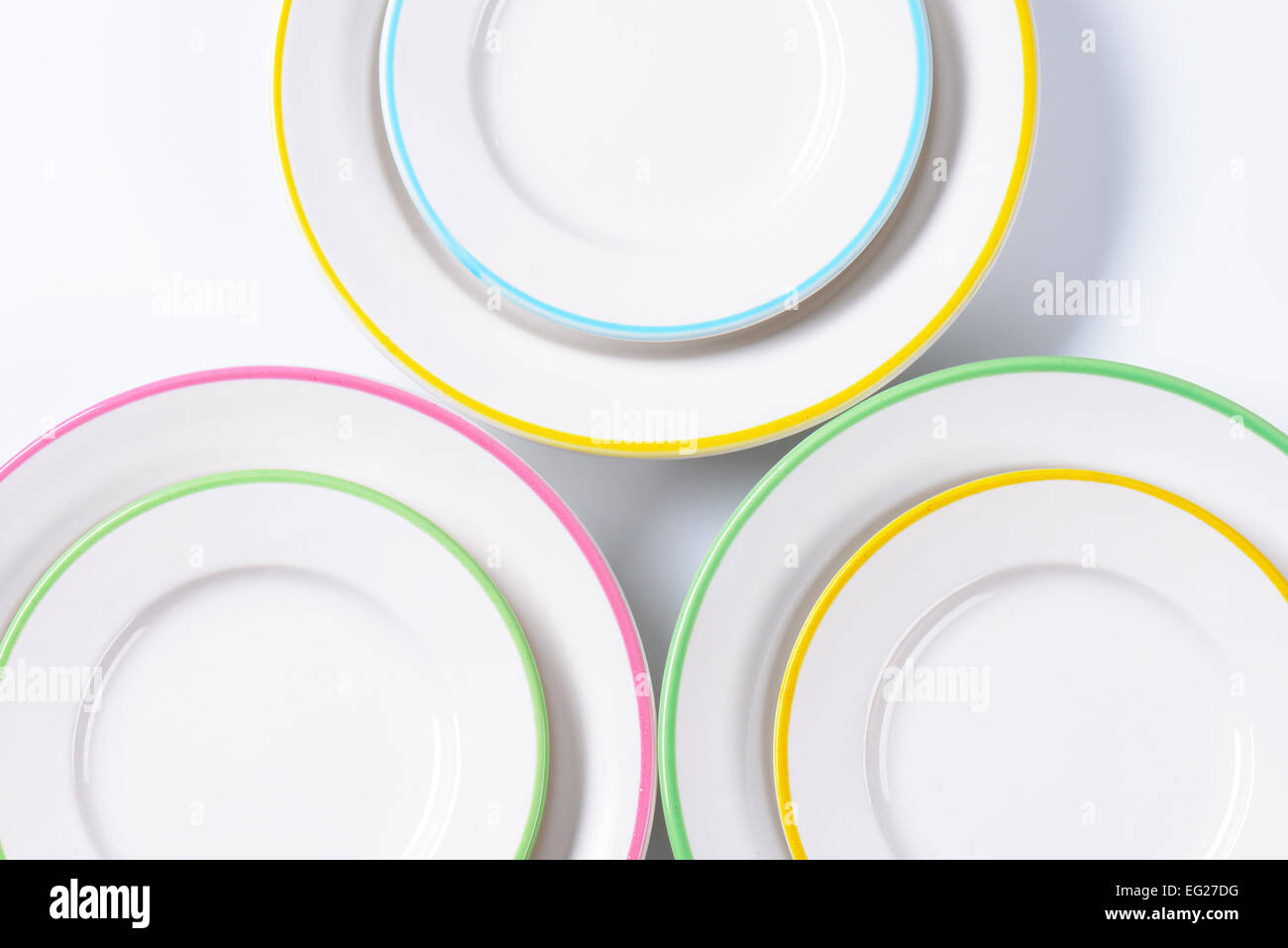 Set of rimmed plates with pastel colored edges Stock Photo - Alamy