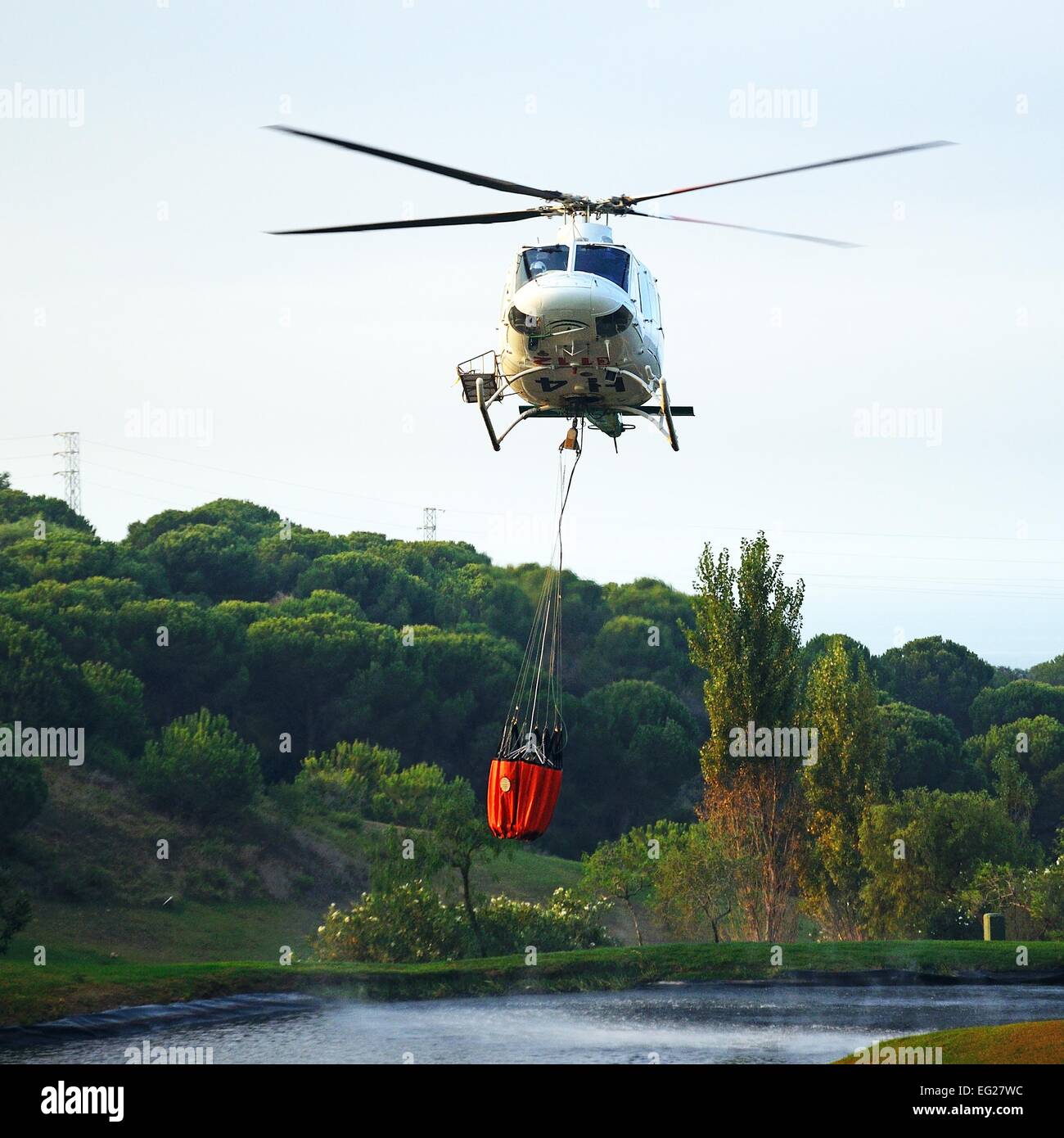 Bell 412 registration EC-IPM collecting water for fire fighting from a ...