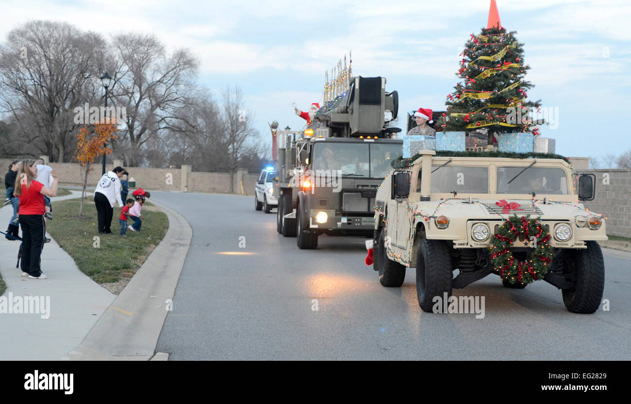 Santa Claus waves to spectators as two 436th Security Forces Squadron vehicles provide escort during the Christmas parade at Dover Air Force Base, Del., Dec. 4, 2012. The Christmas parade kicked off the holiday season on base and was followed by a tree lighting ceremony.  Tech. Sgt. Chuck Walker Stock Photo