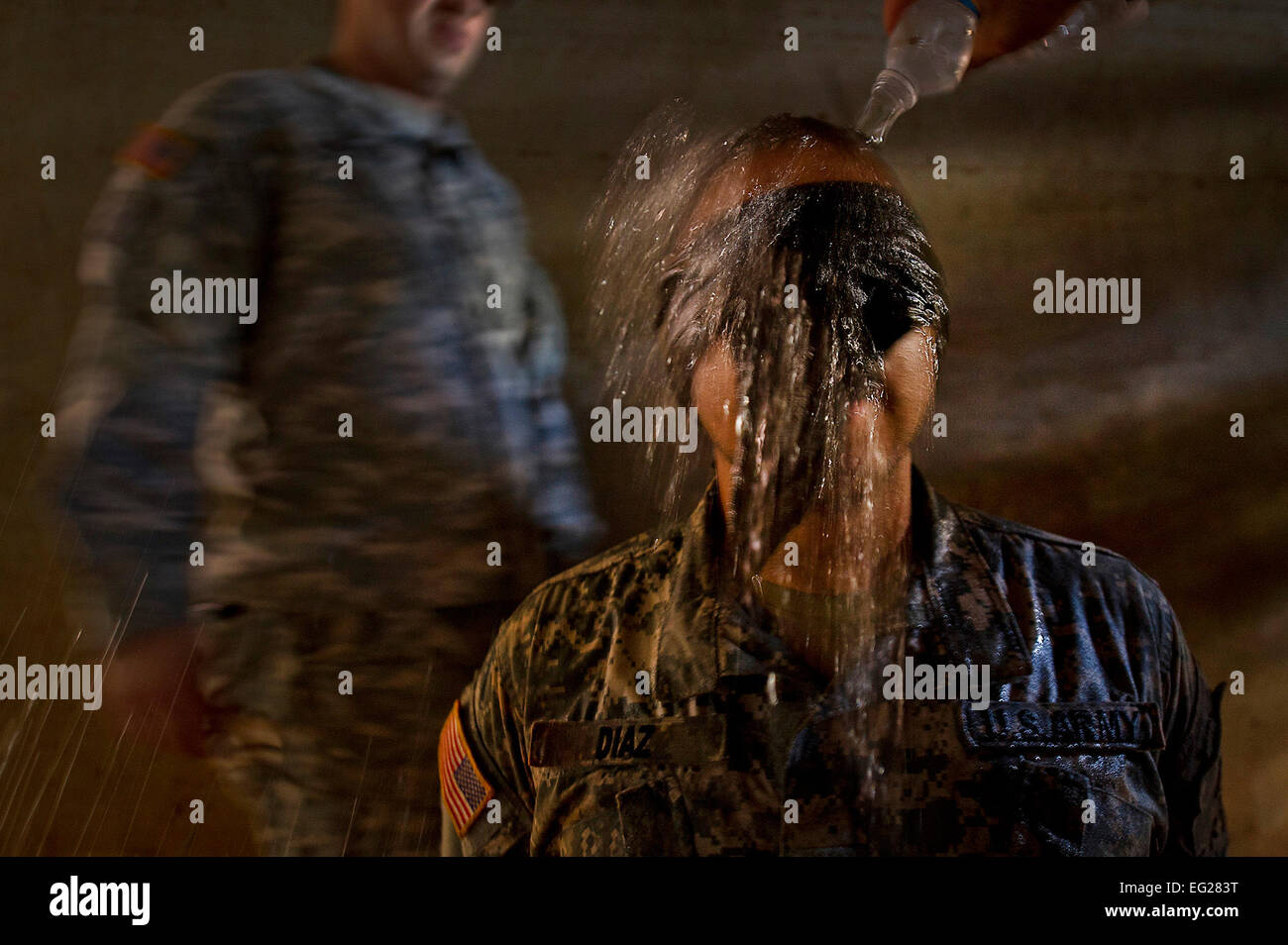 U.S. Army Sgt. Fernando Diaz  is blind folded and has ice-cold water dumped over his head during a mock interrogation by opposition forces prior to a 100 question written test on medical knowledge Aug. 30, 2012, at Schofield Barracks, in Wahiawa, Hawaii. This procedure was as part of the 2012 Pacific Regional Medical Command Best Medic Competition; a 72-hour physical and mental test of U.S. Army Medics leadership, teamwork, tactics, medical knowledge and warrior tasks. Diaz is a combat medic assigned to 568th Medical Company at Camp Humphreys, South Korea. Tech. Sgt. Michael R. Holzworth Stock Photo