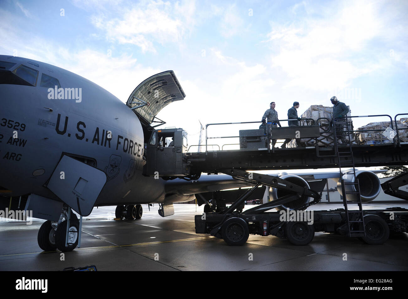 A team of Airmen offload pallets of humanitarian cargo from a U.S. Air Force KC-135 Stratotanker aerial refueling aircraft at Ramstein Air Base, Germany, Dec. 15, 2012.  The cargo was transported by a team of Airmen from MacDill Air Force Base, Fla., for an Air Force Reserve training mission. The mission is part of the Denton Program, a program that allows military aircraft to transport aid supplies on a space-available basis.  The team of Airmen who offloaded pallets is assigned to Ramstein AB.  Staff Sgt. Jennie Chamberlin Stock Photo