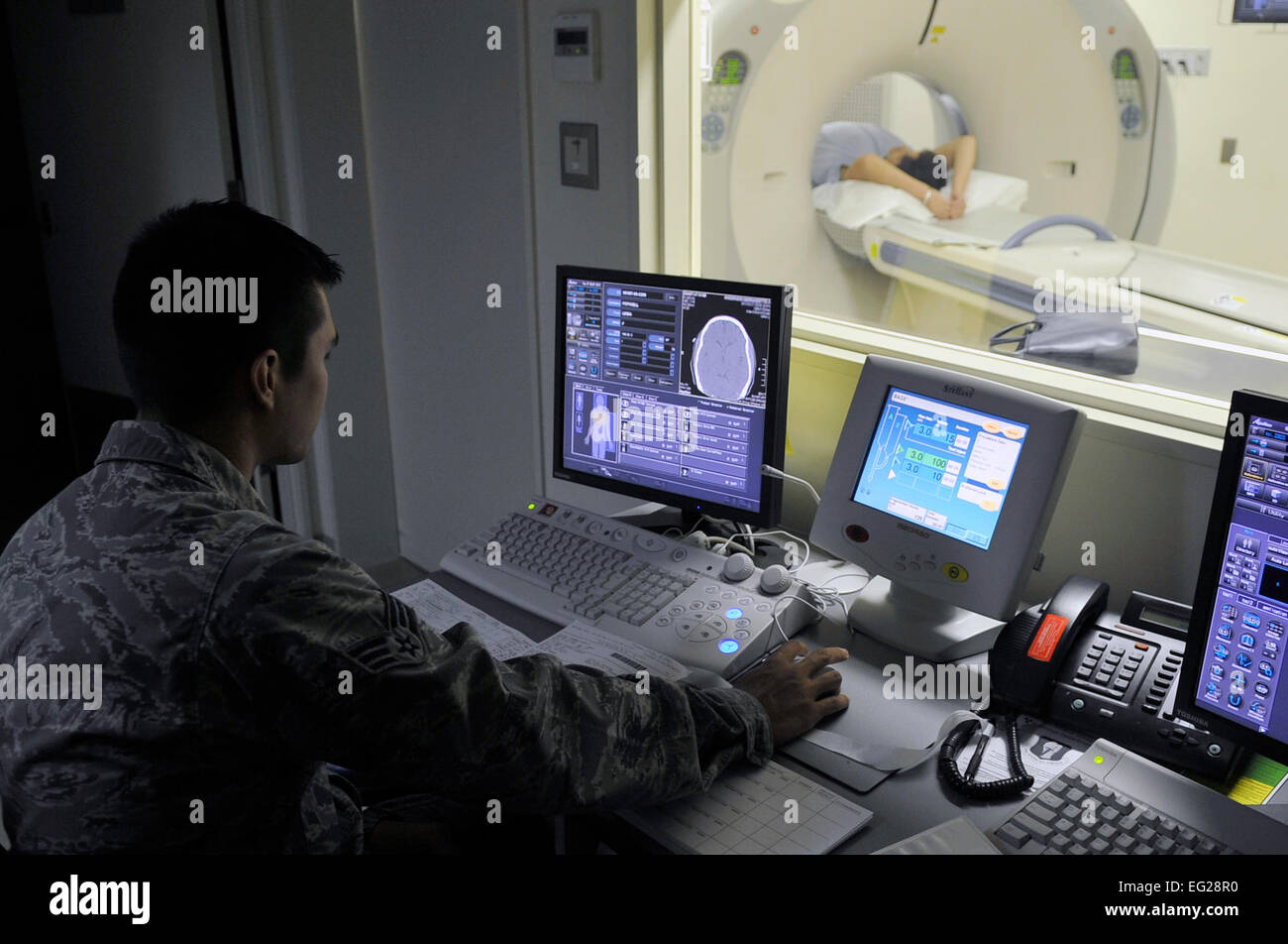 Senior Airman James Lord starts a CT scan Aug. 27, 2013, at Misawa Air Base, Japan. With this monitor, technologists can start and control a scan without being in the same room as the patient or machine. Lord is a 35th Surgical Operations Squadron diagnostic imaging technologist. Airman 1st Class Zachary Kee Stock Photo