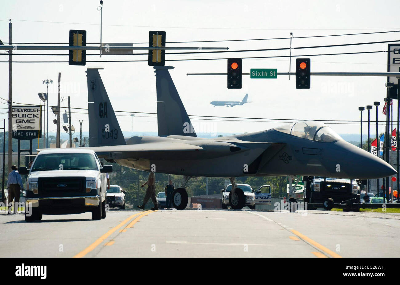 Airmen maneuver through traffic lights while towing an F-15 Eagle down Watson Boulevard Sept. 6, 2014, to the Warner Robins City Hall, Warner Robins, Ga. The aircraft was loaned to the city by the Georgia Air National Guard’s 116th Air Control Wing to serve as a static display for a new veteran’s memorial. The Airmen moving the aircraft are assigned to the 116th Maintenance Group.  Tech. Sgt. Regina Young Stock Photo
