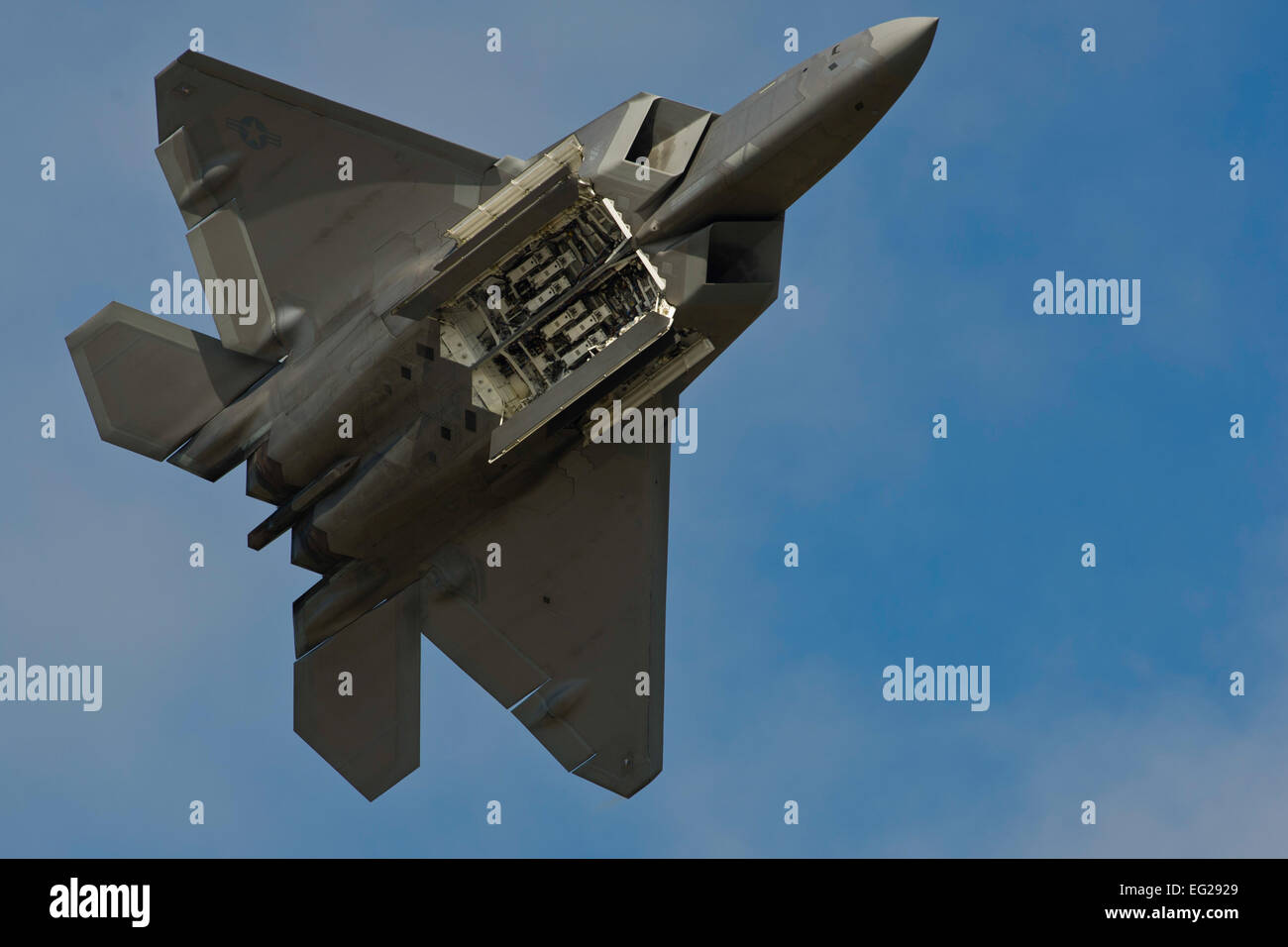 An F-22 Raptor displays its weapons bays to the crowd July 26, 2014 ...