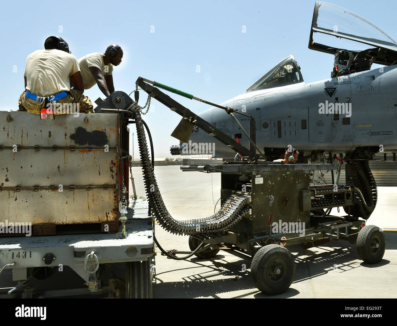 Senior Airman Tristan Franklin and Airman 1st Class Cameron Padgett use an ammunition loading adaptor to feed 30-millimeter rounds into an A-10 Thunderbolt II aircraft ammo drum June 11, 2013, at Bagram Air Field, Afghanistan. The Thunderbolt II can employ a wide variety of conventional munitions, including general purpose bombs, cluster bomb units, laser-guided bombs and joint direct attack munitions. Franklin and Cameron are 455th Expeditionary Aircraft Maintenance Squadron weapons loaders.  Staff Sgt. Stephenie Wade Stock Photo