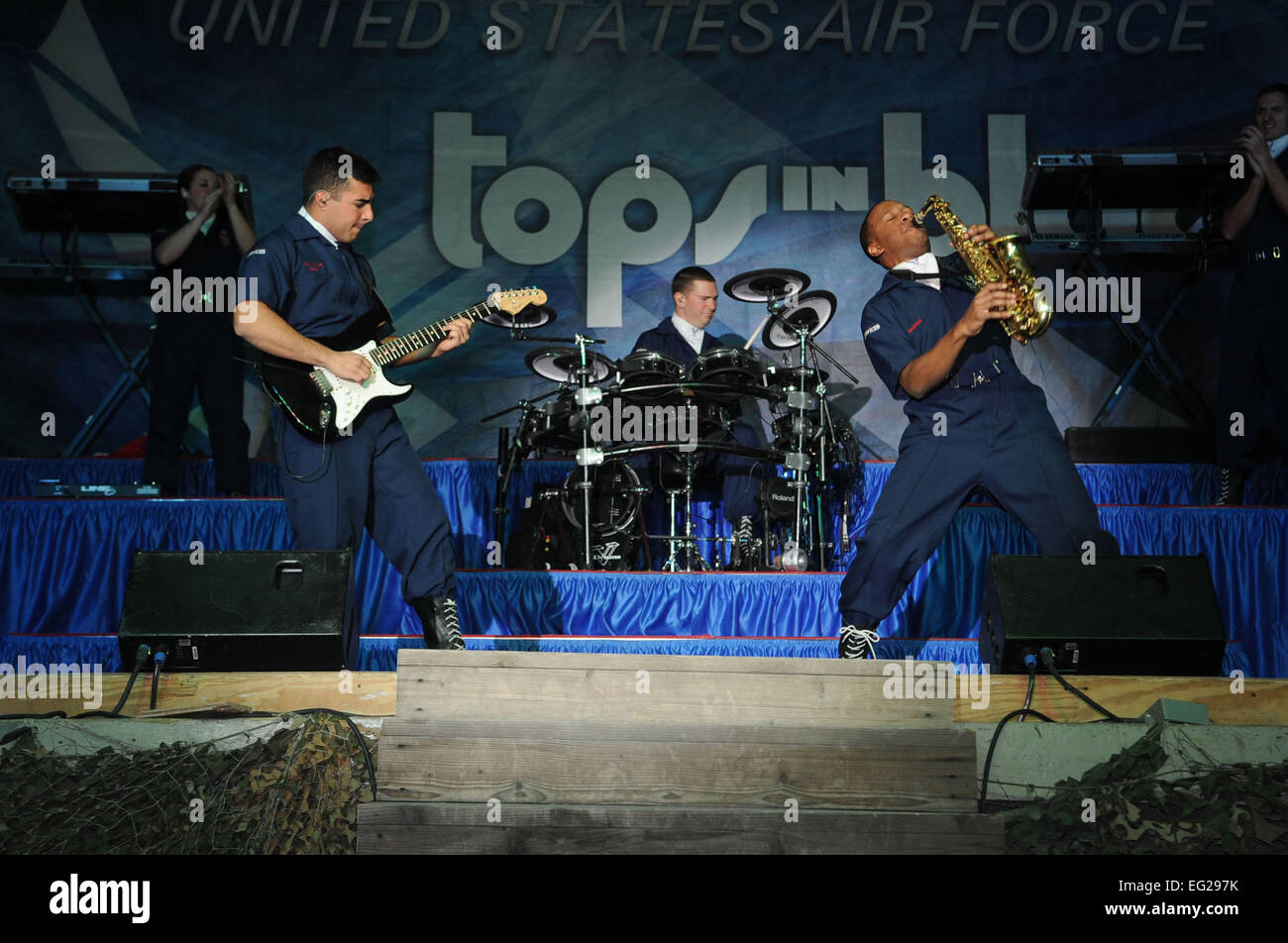 Senior Airman Kenneth Del Valle Ruiz, front left, and Airman 1st Class Wynton Warren, front right, have an instrument duel during a Tops in Blue performance at Bagram Airfield, Afghanistan, Dec. 24, 2012. Tops in Blue serves as an expeditionary entertainment unit that provides quality entertainment to personnel stationed worldwide at remote and deployed locations.  Staff Sgt. David Dobrydney Stock Photo