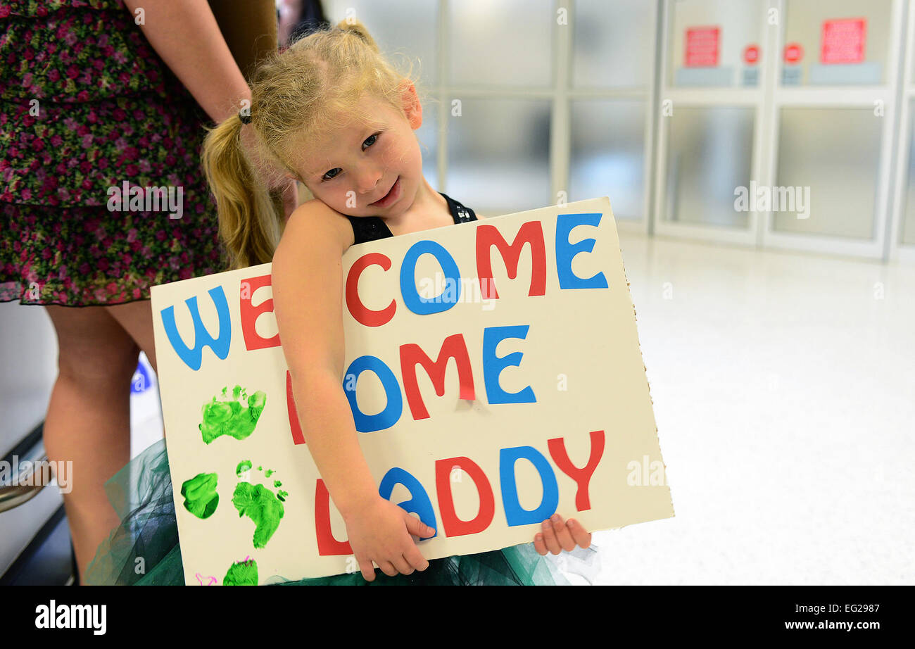 A young girl waits for her father at Royal Air Force Mildenhall, United Kingdom, Sept. 19, 2013, following his four- month deployment to Bagram Airfield, Afghanistan. Nearly 100 Airmen from the 56th Rescue Squadron and 748th Air Maintenance Squadron, stationed at RAF Lakenheath, U.K. returned this week. Airman 1st Class Dana J. Butler Stock Photo