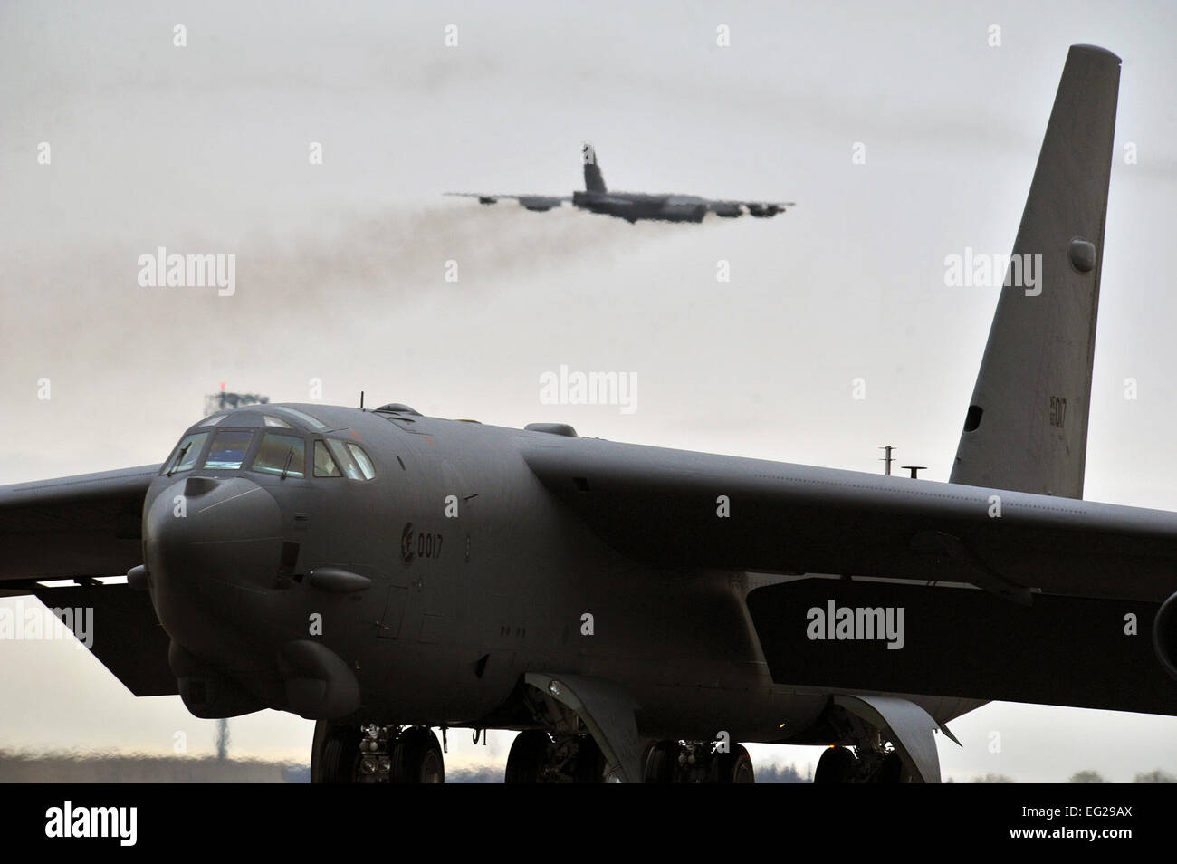 A B-52H Stratofortress takes off as another B-52H taxis onto the runway during a training exercise May 21, 2013, at Minot Air Force Base, N.D.  Senior Airman Brittany Y. Auld Stock Photo