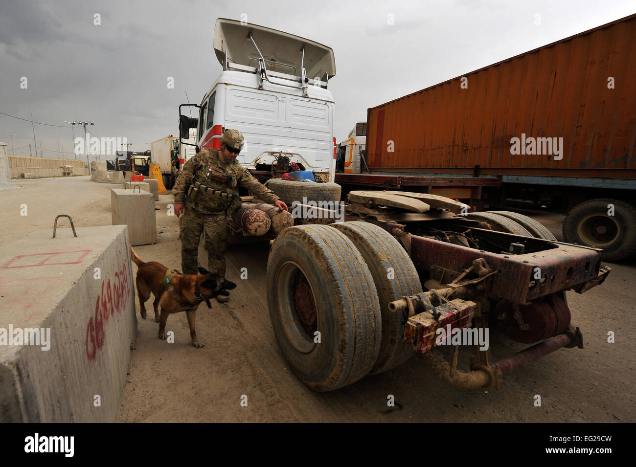 Staff Sgt. Jonathan Cooper, 455th Expeditionary Security Forces Group Military Working Dog handler, deployed from Shaw Air Force Base, S.C., and Military Working Dog Astra search for Vehicle-Borne Improvised Explosive Devices at Bagram Airfield, Afghanistan, April 29, 2013. Vehicles come from all over Afghanistan and must be searched for VBIED threats before they can enter the installation.  Senior Airman Chris Willis Stock Photo