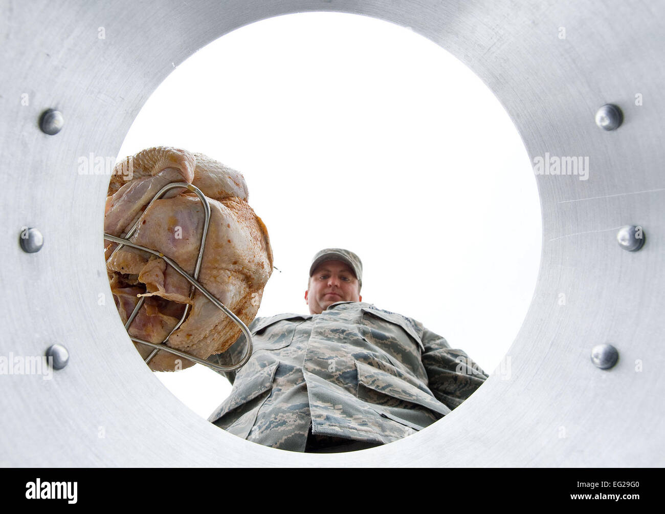 Master Sgt. John Willard lowers a turkey into a turkey fryer at Dover