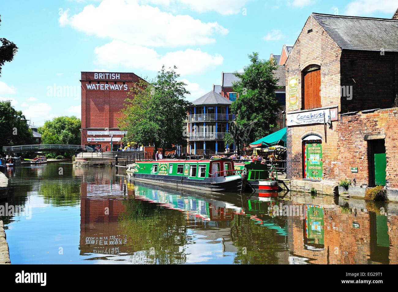 Narrowboats along the Nottingham and Beeston Canal with buildings along the city wharf, Nottingham, Nottinghamshire, England, UK Stock Photo