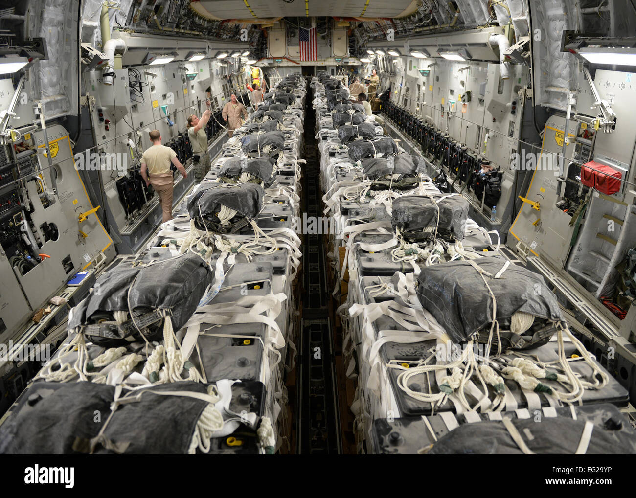 U.S. Army parachute riggers from the 11th Quartermaster Company assemble 40 container delivery system bundles of water onto a C-17 Globemaster III for a humanitarian airdrop over the area if Amirli, Iraq Aug. 30, 2014. Two C-17s dropped 79 bundles of fresh drinking water totaling 7,513 gallons. In addition, two C-130 Hercules dropped 30 bundles containing 3,032 gallons of water and 7,056 Halal Meals Ready to Eat.  Staff Sgt. Shawn Nickel Stock Photo
