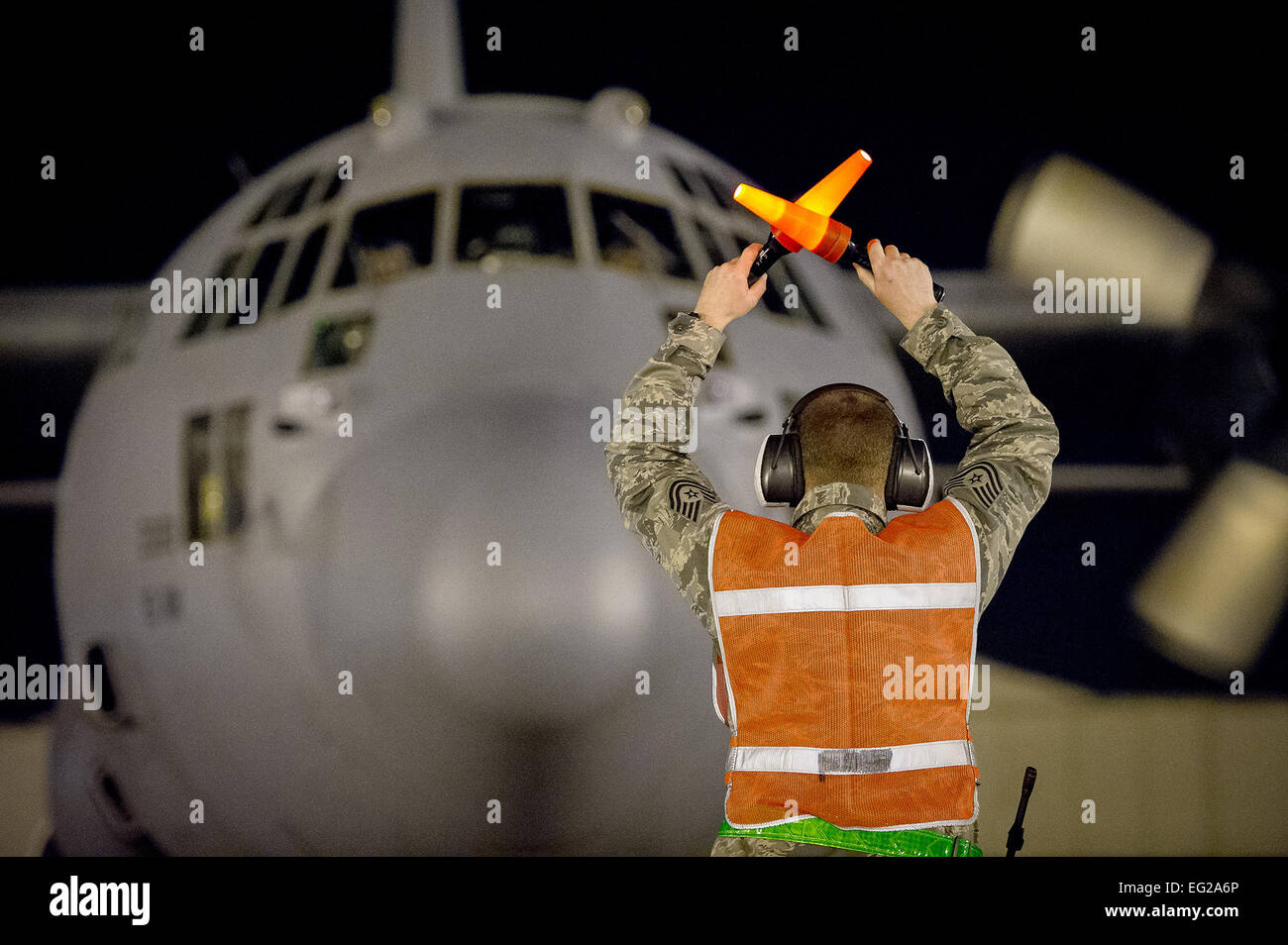 Tech. Sgt. David Drain marshals a C-130 Hercules aircraft in Alexandria, La., Feb. 21, 2013, in support of Joint Readiness Training Center aeromedical evacuation training. Drain is assigned to the 305th Aerial Port Squadron at Joint Base McGuire-Dix-Lakehurst, N.J. Service members at the training center are educated in combat patient care and aeromedical evacuation in a simulated combat environment. Tech. Sgt. John R. Nimmo, Sr. Stock Photo