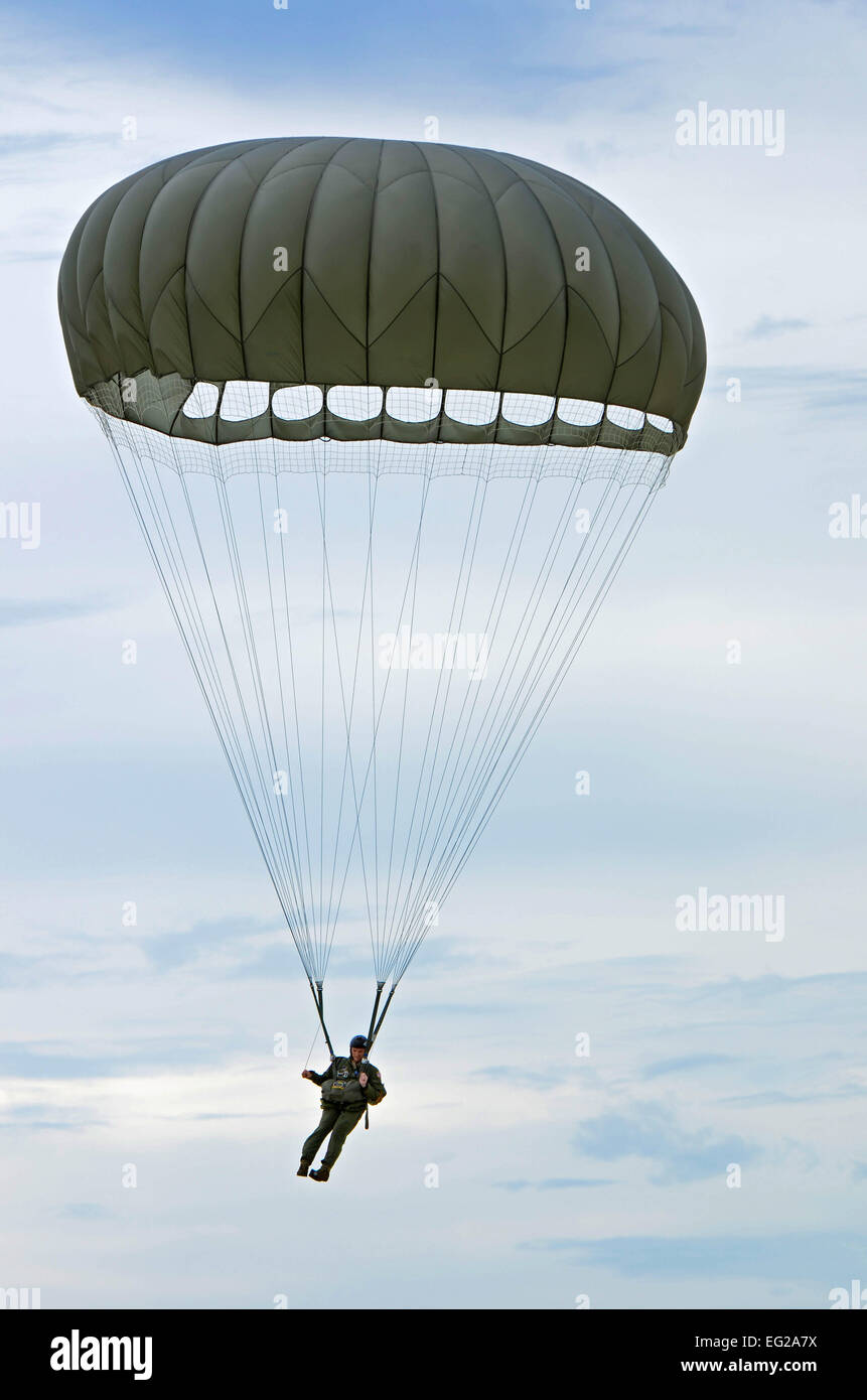 Staff Sgt. Daniel Guy, 736th Security Forces Squadron fire team leader, makes his way to the ground Aug. 21 after jumping from a C-130 Hercules over Andersen Air Force Base, Guam. Air Force static line capability falls under the Personnel Parachute program. Jumpers are first qualified during a three-week basic airborne course at Ft. Benning, Ga., then continue to work on their jumping proficiency and qualifications after they return to home station.  Airman 1st Class Marianique Santos Stock Photo