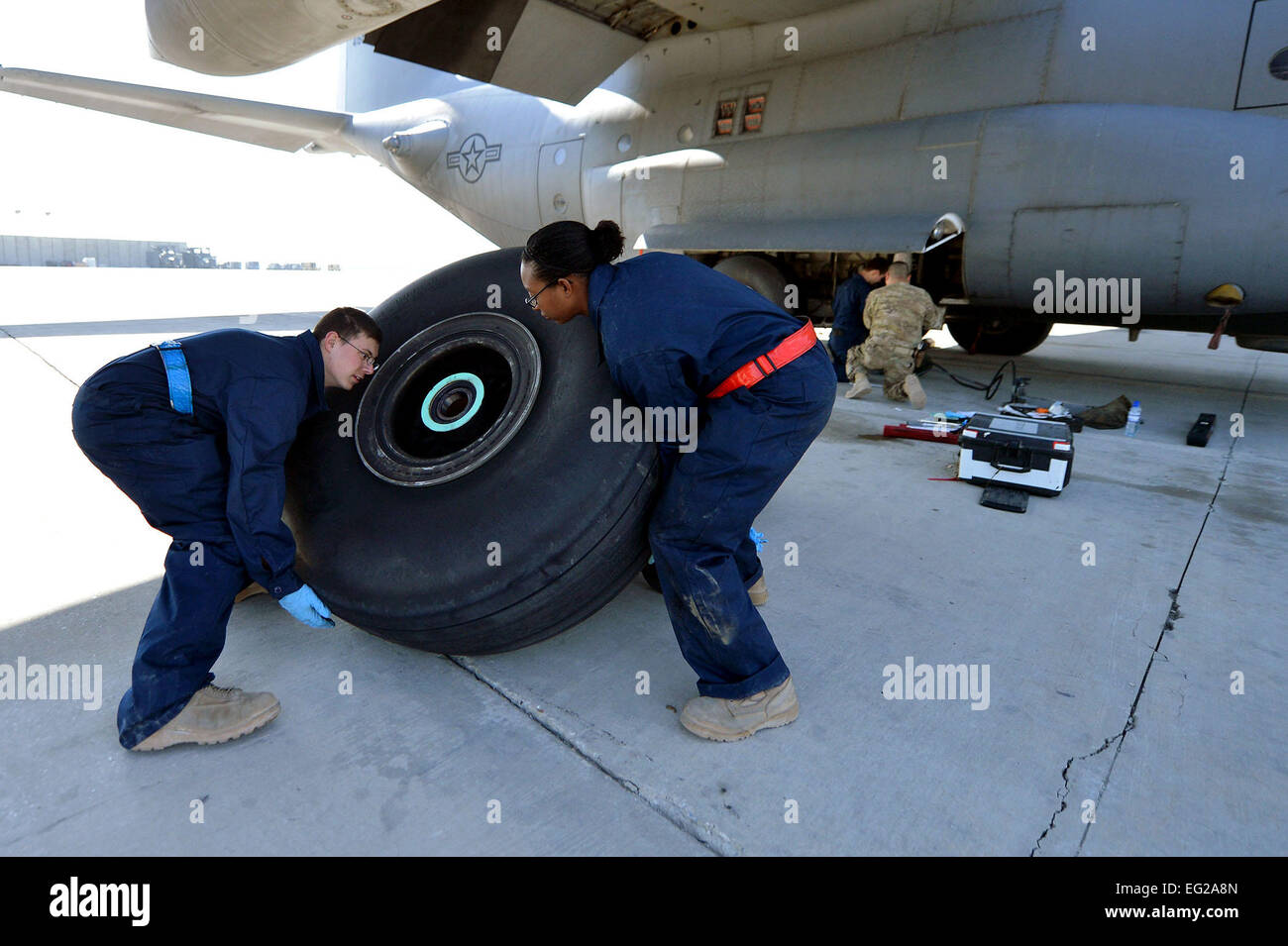 Crew chiefs assigned to the 455th Expeditionary Aircraft Maintenance Squadron replace a tire on a C-130 Hercules, March 6, 2013, on Bagram Airfield, Afghanistan. The crew is deployed from Little Rock Air Force Base, Ark. Senior Airman Chris Willis Stock Photo