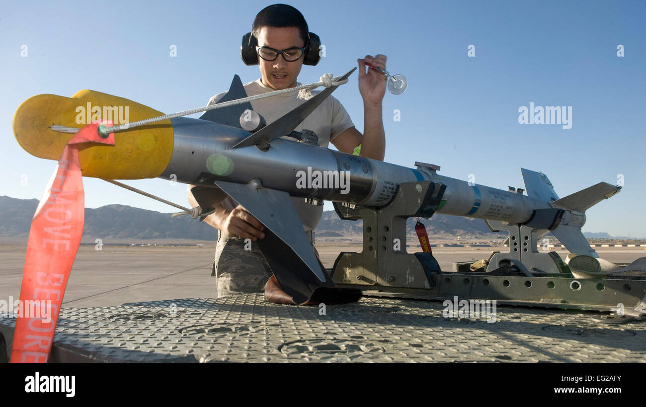 Senior Airman Jonathan Gonzalez inspects an AIM-9 Sidewinder air-to-air missile during a quarterly load crew competition at Nellis Air Force Base, Nev., July 6, 2012. The load crew competition gives the crews an opportunity to display their skills to the wing. Gonzales is a weapons load crew member with the 757th Aircraft Maintenance Squadron  Airman 1st Class Matthew Lancaster Stock Photo