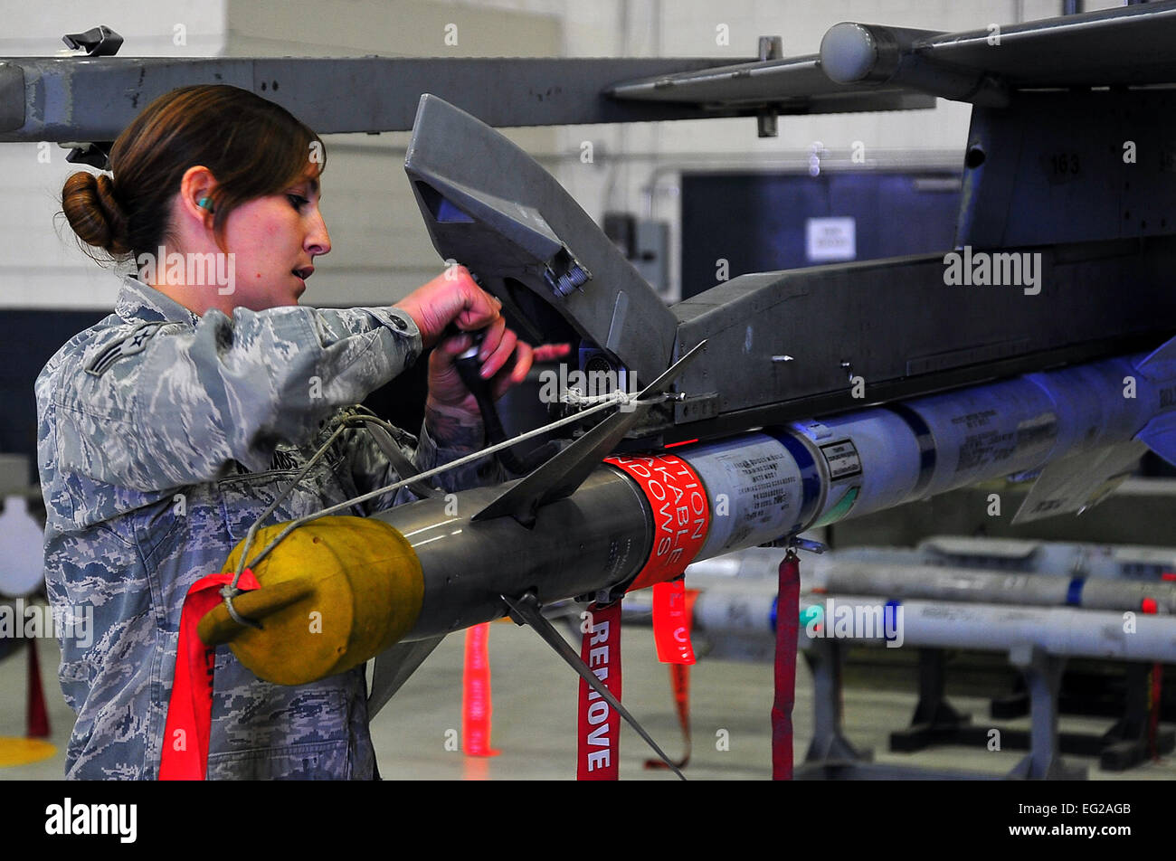 Senior Airman Faith Richards secures an AIM-9 Sidewinder missile onto an F-16 Fighting Falcon during a load crew team competition Jan. 25, 2013, at Osan Air Base, South Korea. Richards is a 36th Aircraft Maintenance Unit weapons loader. Staff Sgt. Emerson Nunez Stock Photo
