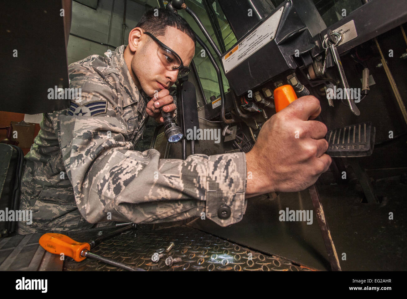 Senior Airman Christopher Garcia removes a panel to fix a neutral start switch on a 10K forklift Jan. 10, 2015, on Joint Base McGuire-Dix-Lakehurst, N.J.  Master Sgt. Mark C. Olsen &quot;For more photos from around the Air Force, visit our Facebook page at facebook.com/usairforce.&amp;quot  http://facebook.com/usairforce.&amp;quot  ; United States Air Force Stock Photo