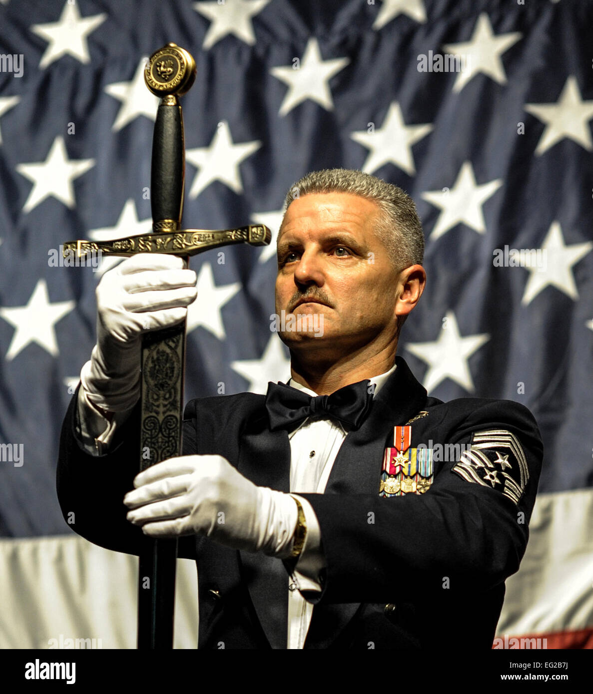 Chief Master Sgt. Bruce Nixon holds the sword that was presented to retired Gen. Norton Schwartz during an Order of the Sword ceremony on Okaloosa Island, Fla., Feb.1, 2013. The Order of the Sword is an honor awarded by the NCOs of a command to recognize individuals they hold in high esteem and for their contributions to the enlisted corps. Nixon is the command chief of 24th Special Operations Wing. Airman 1st Class Christopher Callaway Stock Photo