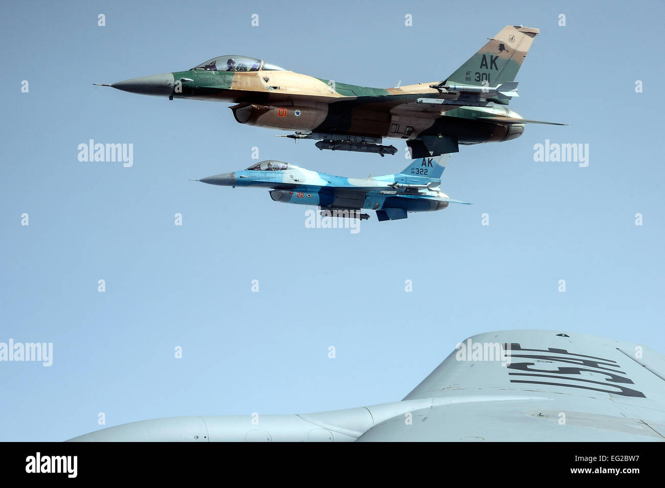 Two F-16 Fighting Falcons from the 18th Aggressor Squadron fly alongside a KC-135 Stratotanker during Red Flag-Alaska 14, May 15, 2014 over the Joint Pacific Alaska Range Complex. The 18th AS out of Eielson Air Force Base, Alaska, trains allied and coalition forces with real-world combat scenarios by mimicking adversarial flying techniques.  Senior Airman Zachary Perras Stock Photo