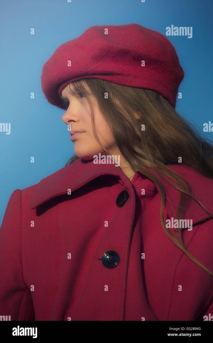 portrait of a young girl with red coat and red hat Stock Photo