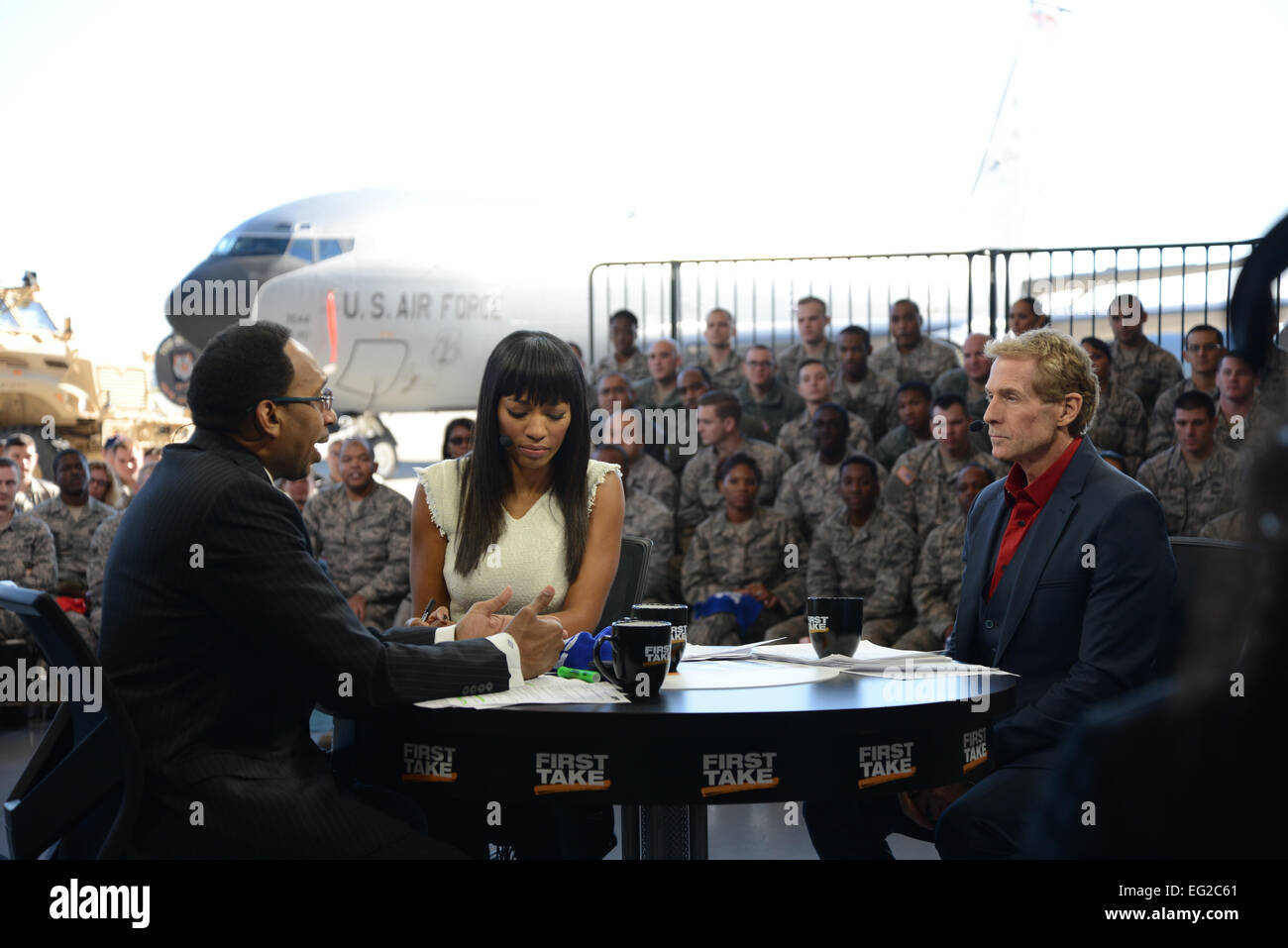 Airmen with the 108th Wing attend a special live broadcast of ESPN’s “First Take” hosted by Stephen A. Smith, Skip Bayless and Cari Champion, Nov. 10, 2014, at Joint Base McGuire-Dix-Lakehurst, N.J. The “Salute the Troops” broadcast, in honor of Veterans Day, was set with a backdrop of a KC-10 Extender, KC-135 Stratotanker and other military vehicles.  Tech. Sgt. Carl Clegg Stock Photo