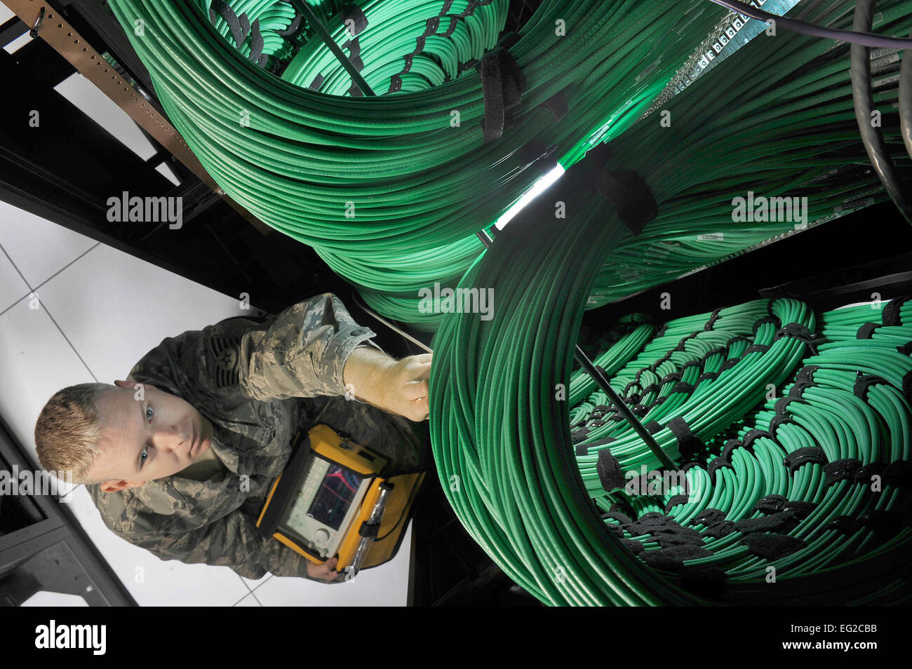 Tech. Sgt. Wyatt Bloom uses a spectrum analyzer to check television broadcast network routers at the Defense Media Activity’s Headquarters at Fort Meade, Md., July 18, 2012. Bloom is a cyber-transport technician assigned to DMA.  Val Gempis Stock Photo