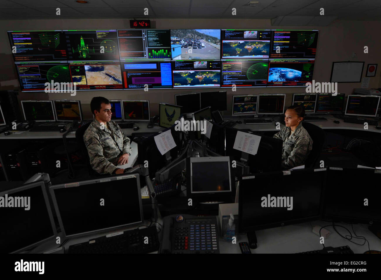 Staff Sgt. Alex Garviria and 2nd Lt. Rachel James work in the Global Strategic Warning and Space Surveillance System Center Sept. 2, 2014, at Cheyenne Mountain Air Force Station, Colo. Garviria is a 721st CS senior systems controller and James is the 721st CS crew commander.  Airman 1st Class Krystal Ardrey Stock Photo