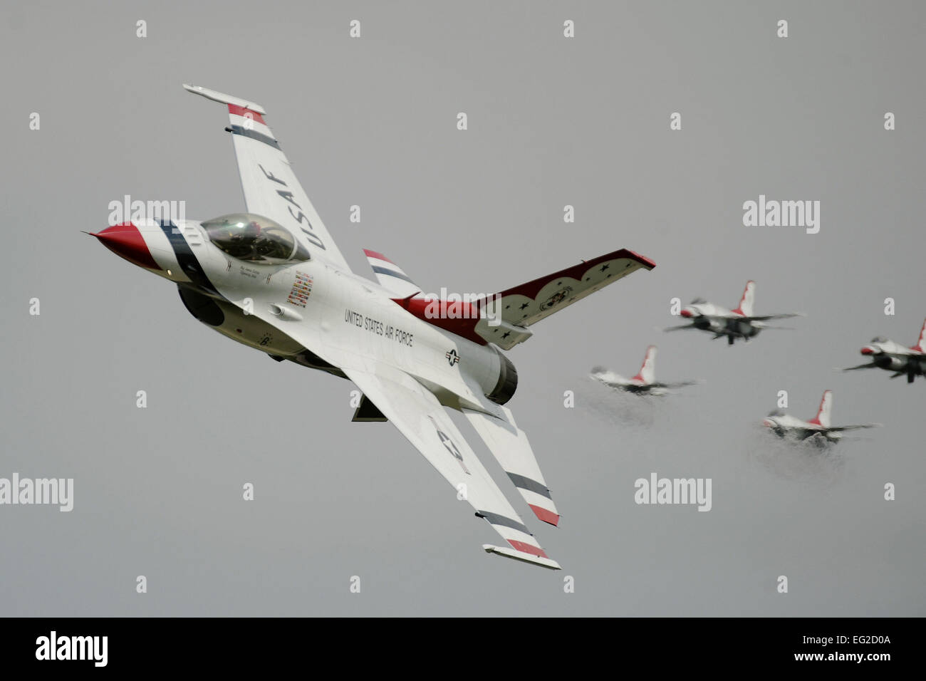 F-16 Fighting Falcons  with the U.S. Air Force Thunderbirds Demonstration Team perform aerial maneuvers Aug. 3, 2014, during the Experimental Aircraft Association's annual AirVenture event in Oshkosh, Wisc.  Master Sgt. Stan Parker Stock Photo