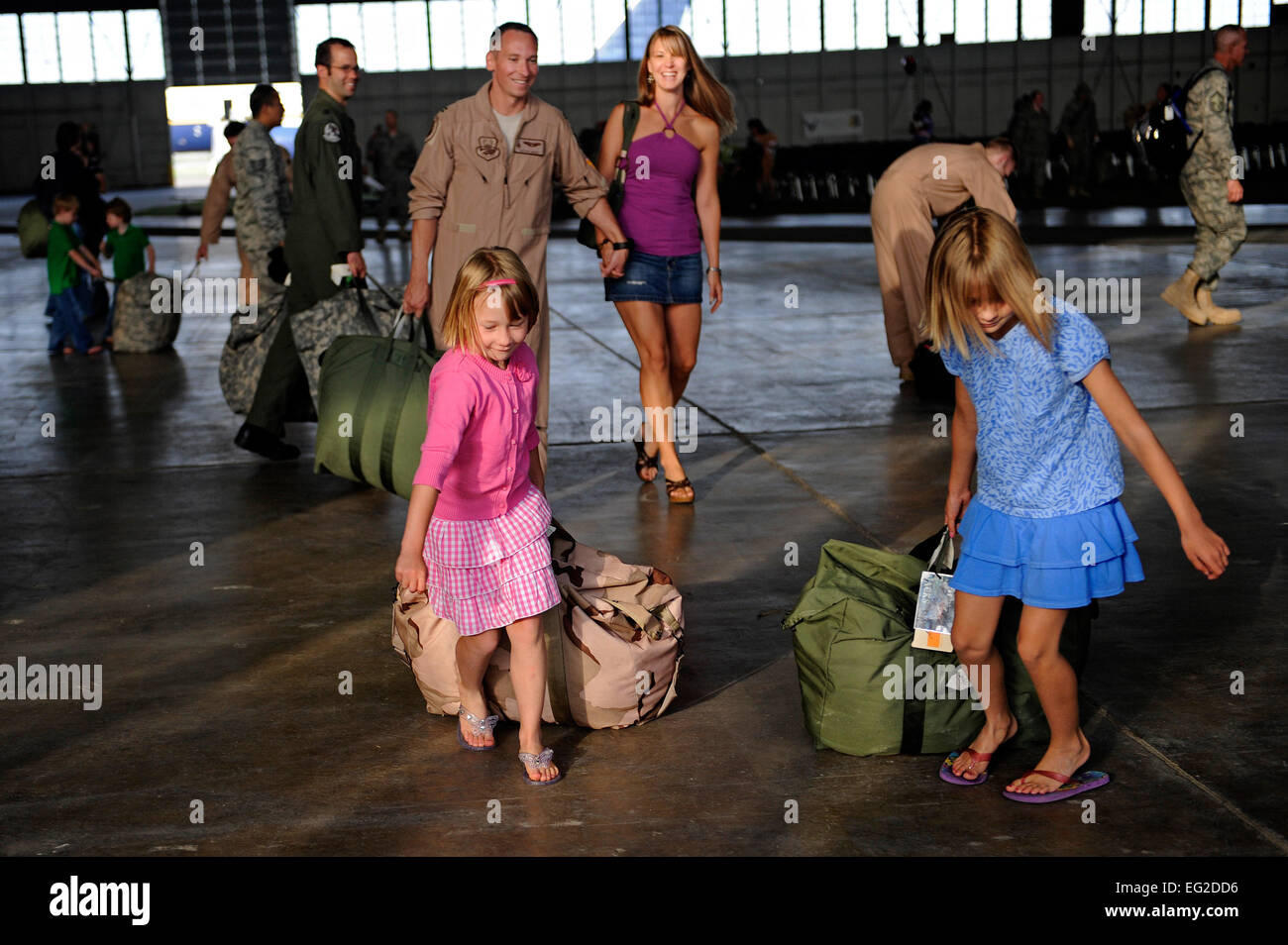 Everyone is all smiles as Capt. William Jacks walks with his wife, Nicole, and daughters, Rachel left  and Anna, after returning home from a six-month deployment to Southwest Asia, July 28, 2010, at Ellsworth Air Force Base, S.D. Captain Jacks is a B-1B Lancer pilot assigned to the 34th Bomb Squadron. U.S. Air Force photo BY Staff Sgt. Marc I. Lane Stock Photo