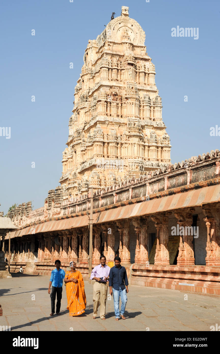 Hampi, India - 13 January 2015: People walking in front of View of Shiva-Virupaksha Temple located in the ruins of ancient city Stock Photo