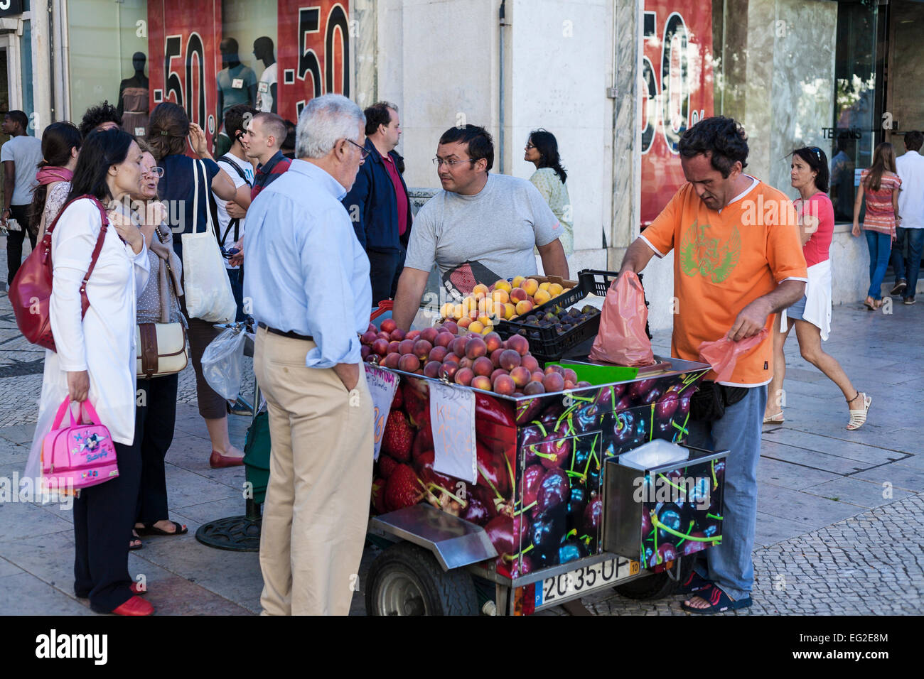 Street vendors selling fruit at a stall  in central Lisbon Stock Photo