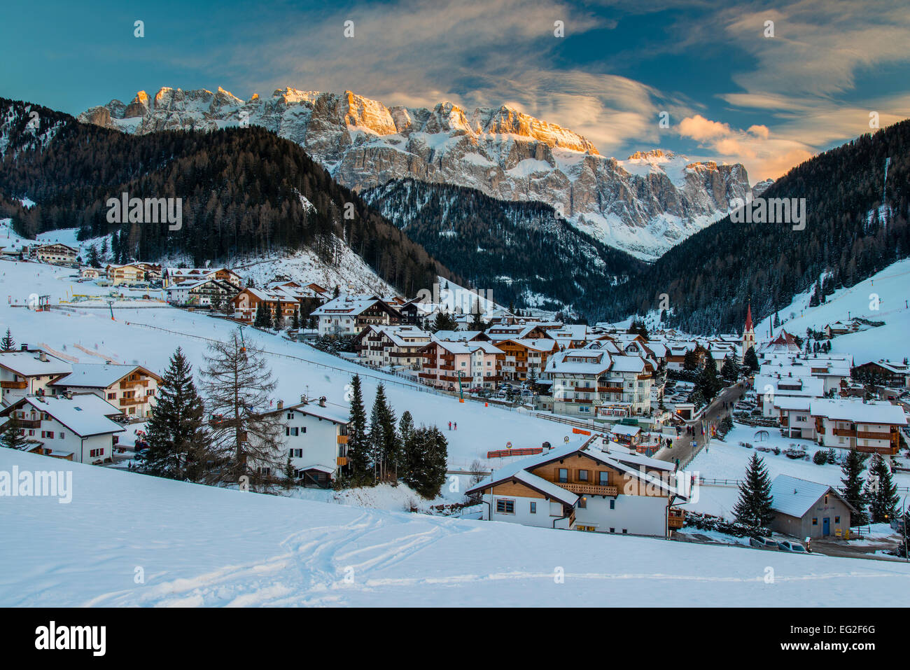 Winter view at sunset of Selva di Val Gardena with Sella massif in the background, Dolomites, Alto Adige - South Tyrol, Italy Stock Photo