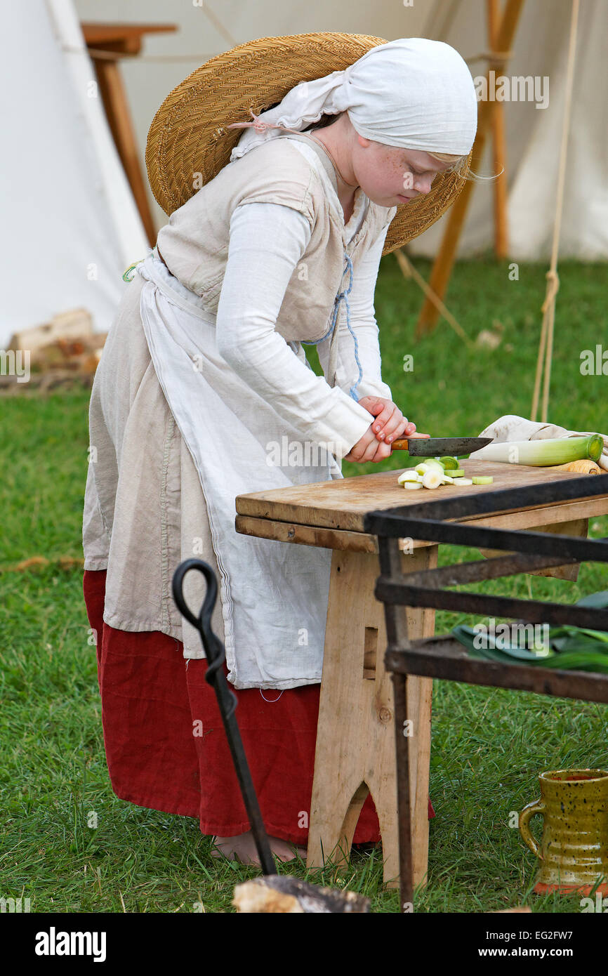 Lincoln Castle Garrison Living Historians depict C15th English life. Lucinda Coultas chops a leek for the meal Stock Photo