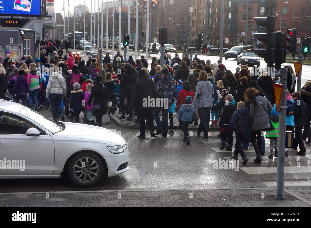 Children with parents go over the pedestrian crossing Stock Photo