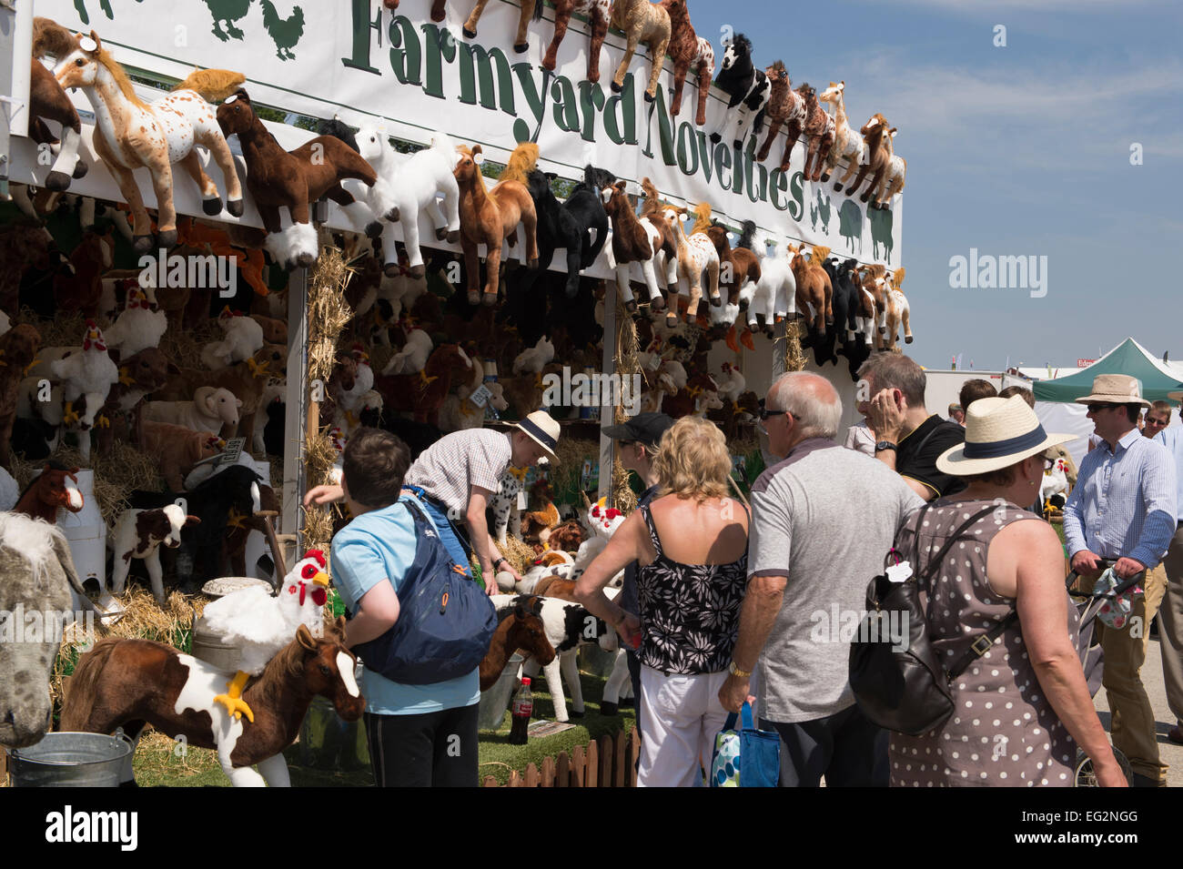 On a hot sunny day, people are milling around a trade stand selling & displaying cute cuddly toys - The Great Yorkshire Show - Harrogate, England, UK. Stock Photo